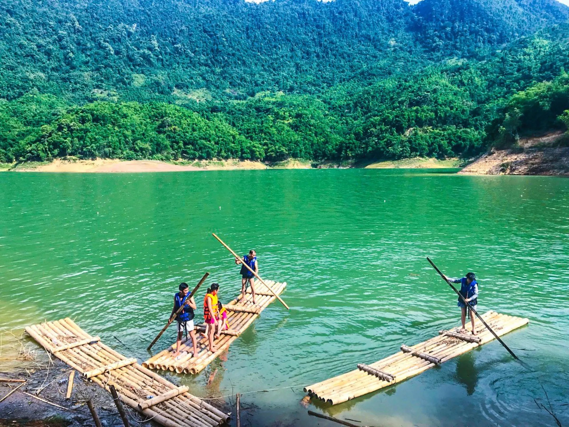 Bamboo rafts on the calm jade water of a lake in northern Vietnam.
