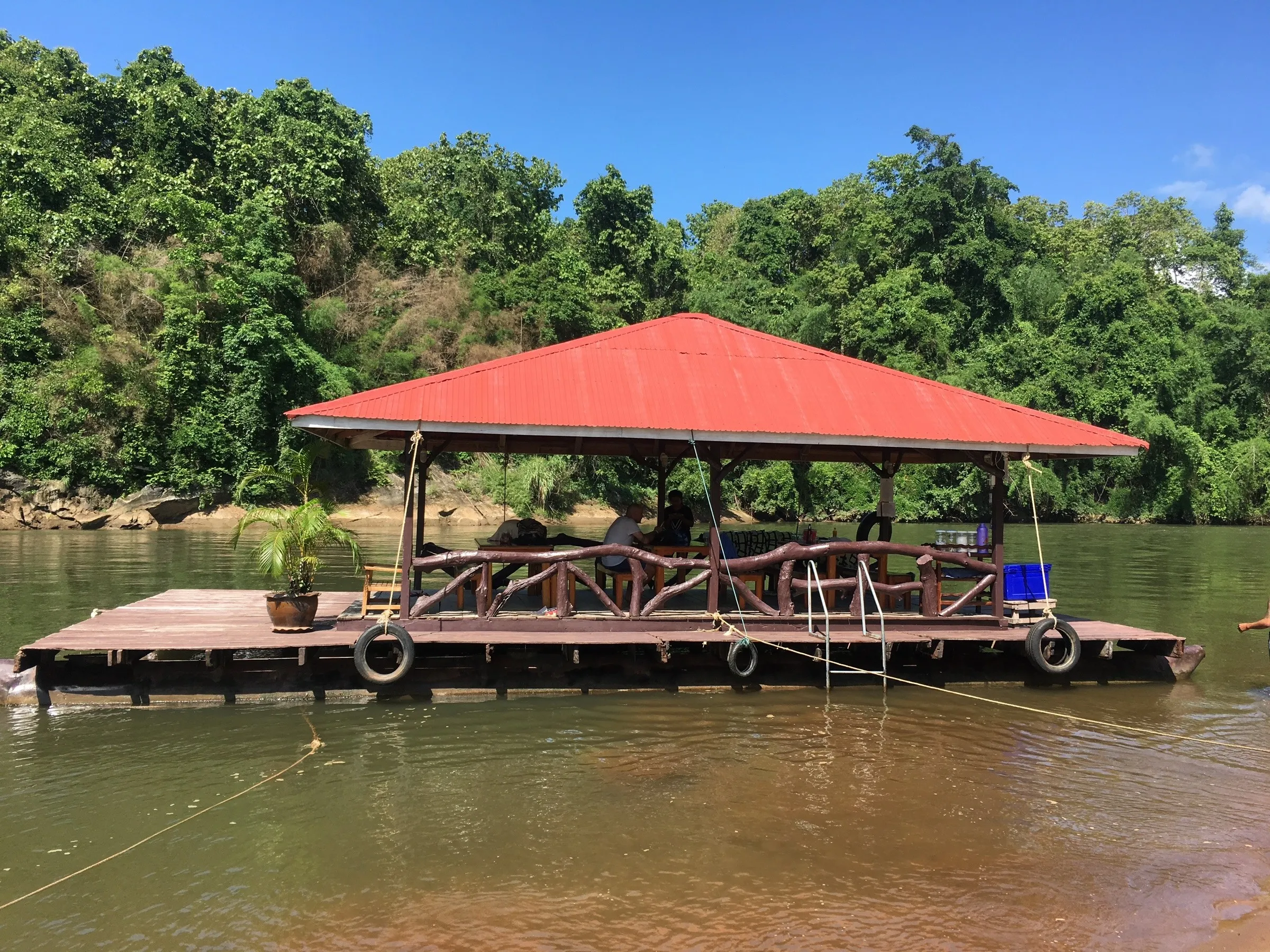 Lunch served under the roof of a bamboo raft drifting down the River Kwai, Sai Yok, Thailand.
