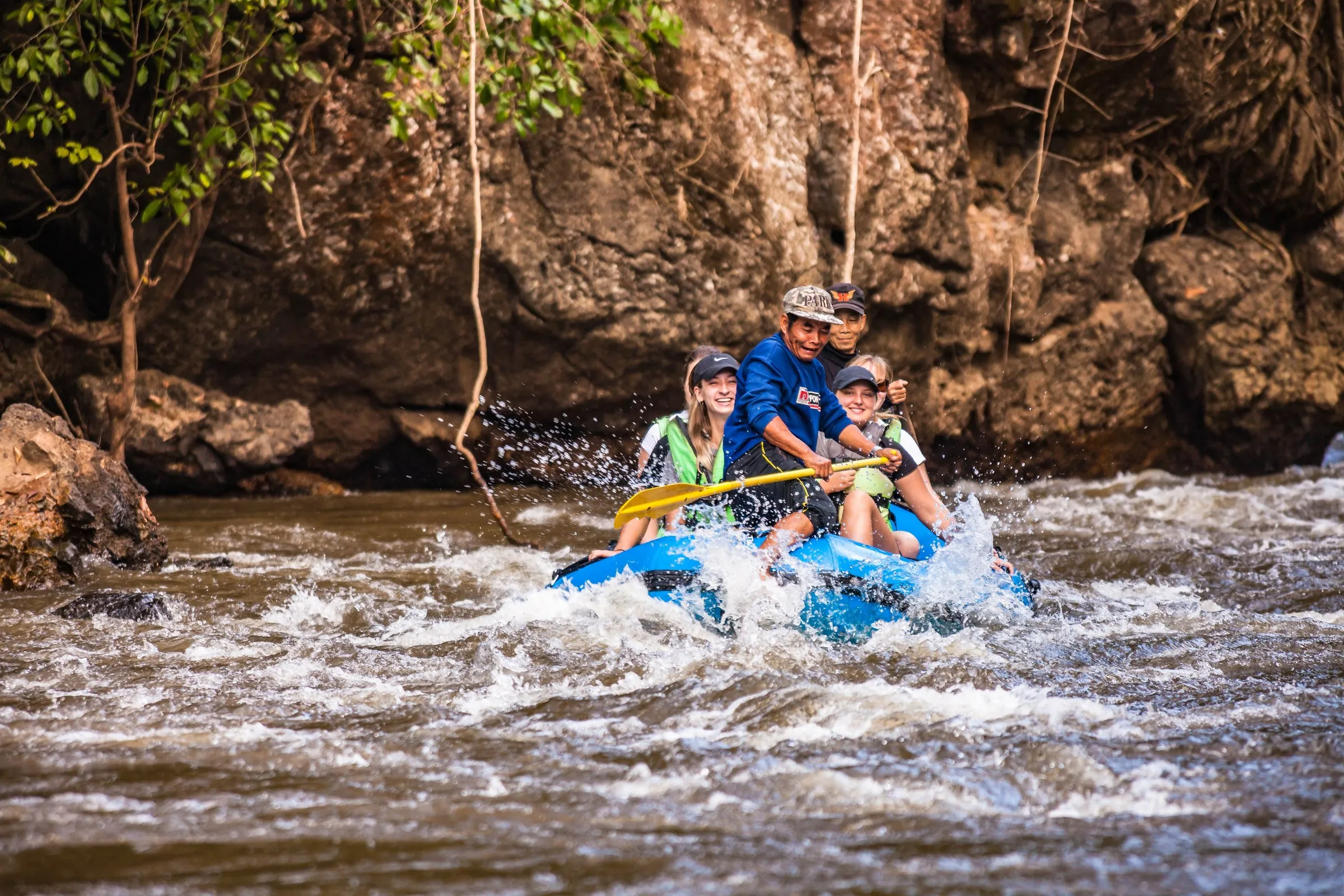 Rafting through whitewater on a jungle river in Umphang, Thailand.