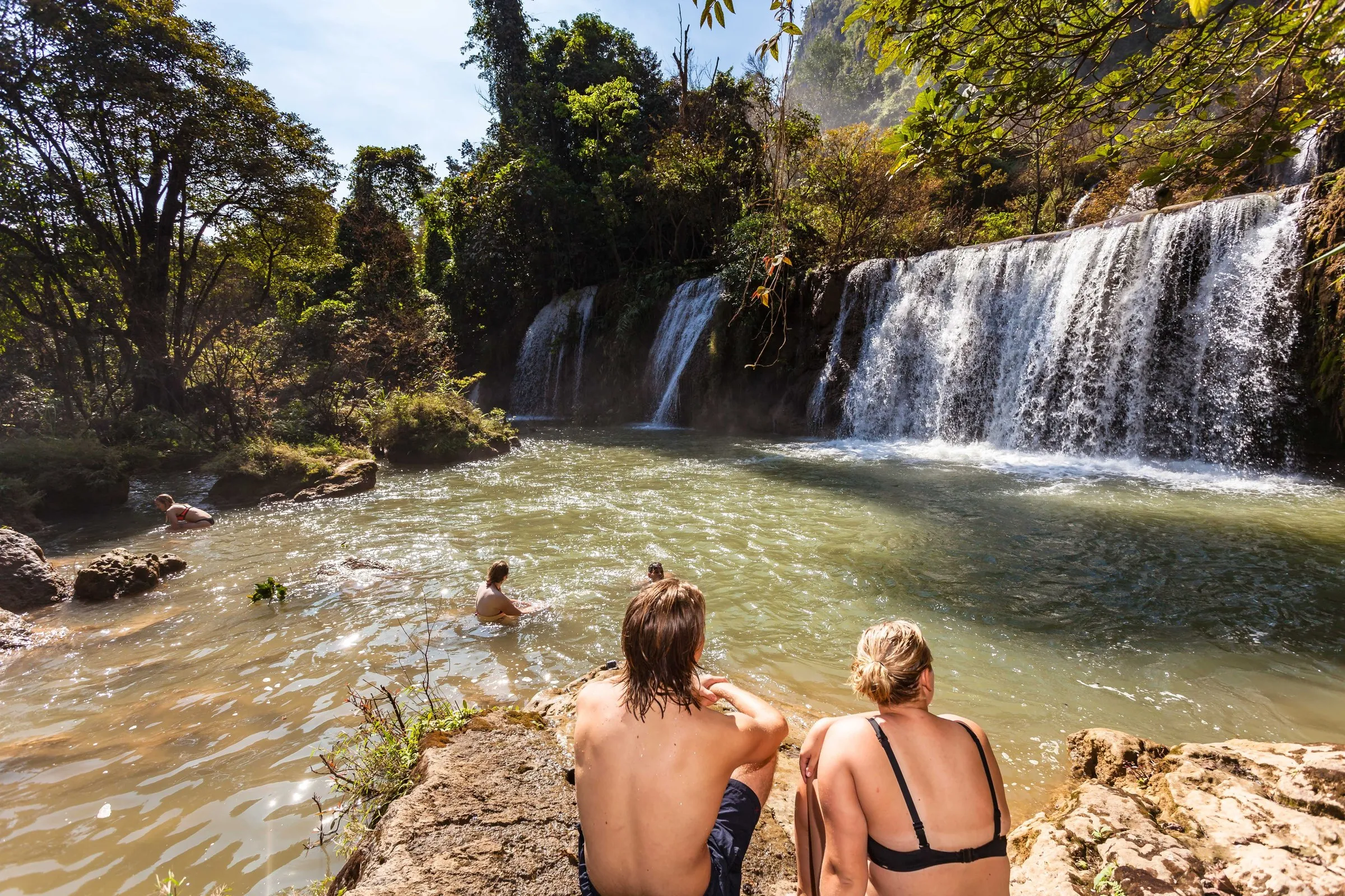 A traveller swimming below Thi Lor Su waterfall, Umphang, Thailand.