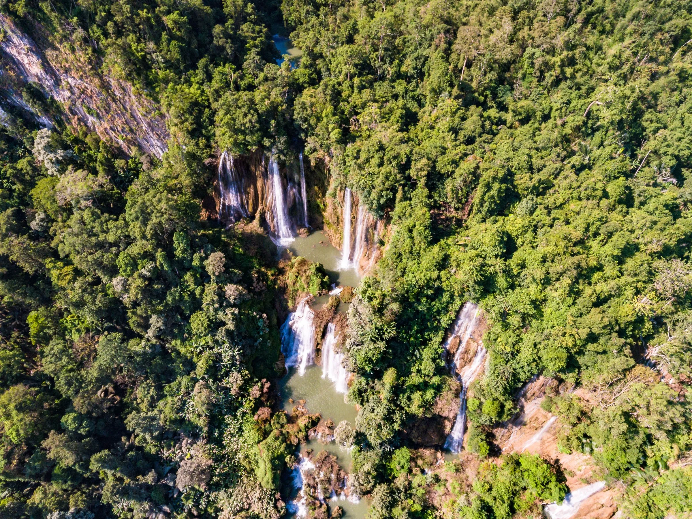 Aerial view of Thi Lor Su waterfall pouring through dense green jungle in Umphang.